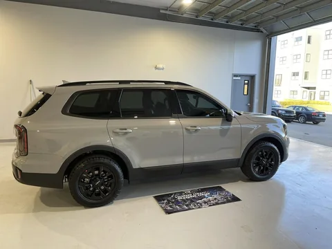 Gray Kia Telluride side profile in the white bay