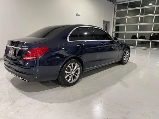 Navy Mercedes C-Class from the rear in the bright bay