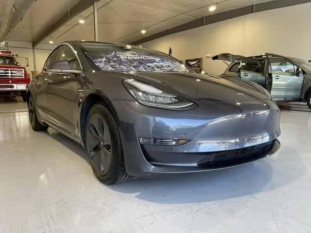 Gray Tesla Model 3 from the front in the shop